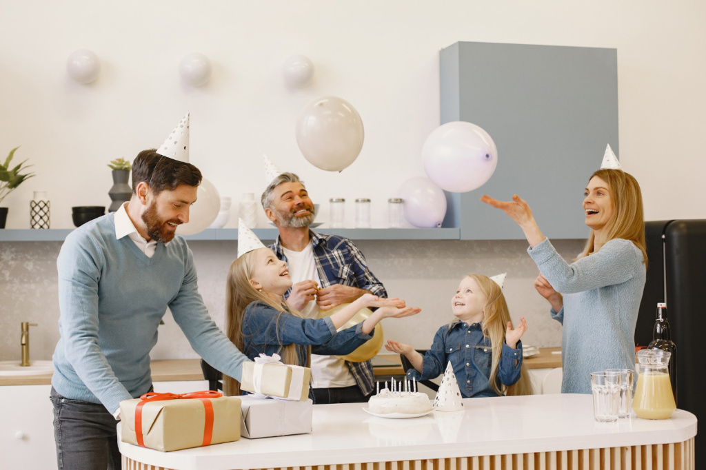 family-two-their-daughters-have-celebration-people-have-baloons-present-are-table.jpg